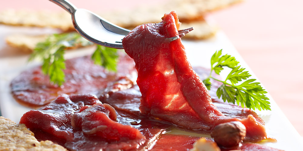 La décoration de la main du chef salade de viande par des pinces